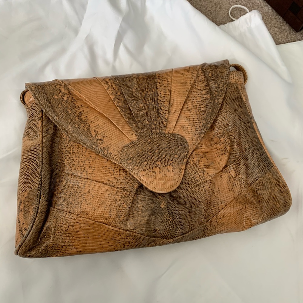 Purchased in Hawaii snake-skin I am told attached shoulder strap
